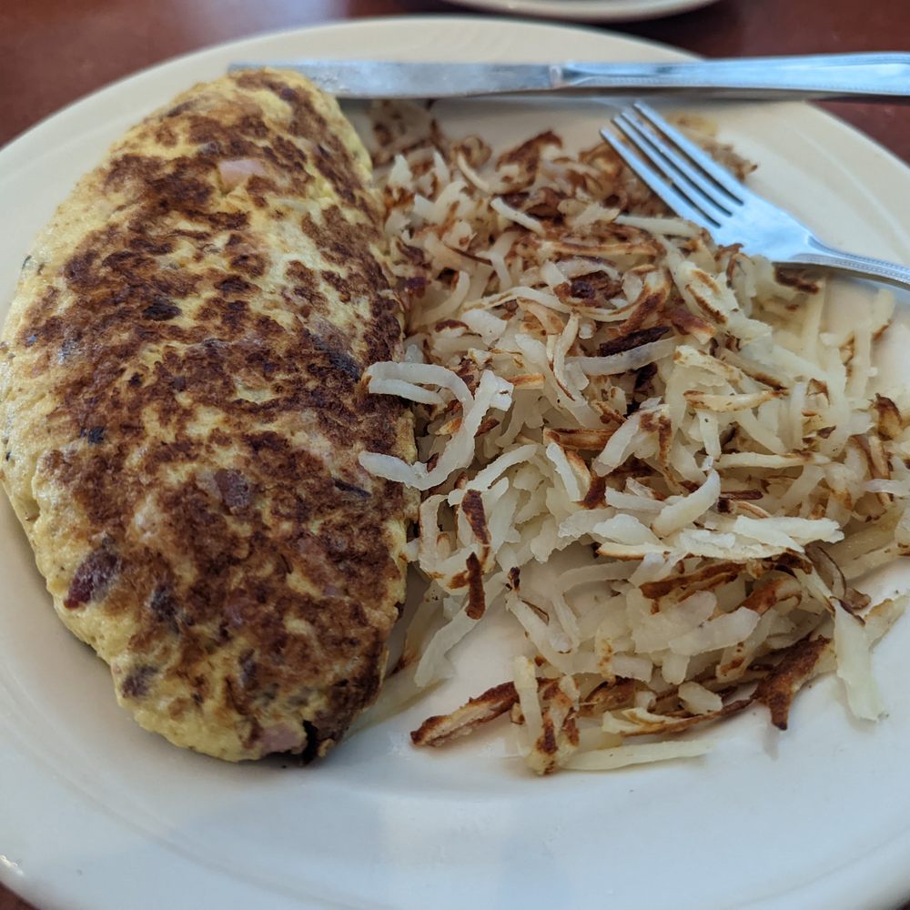 Hash browns and the Aloha omelette (hack cheese, pineapple, potatoes, and ham). Hash browns and the Aloha omelette (hack cheese, pineapple, potatoes, and ham).