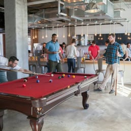 Photo of Yelp - San Francisco, CA, United States. Yelp employees playing pool at Yelp HQ