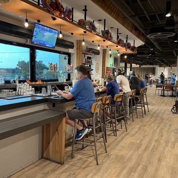 Heim Barbecue - River - Bar area with lots of seating and multiple televisions playing assorted games. - Barbeque Near Me - Fort Worth, Texas Heim Barbecue - River - Bar area with lots of seating and multiple televisions playing assorted games. - Barbeque Near Me - Fort Worth, Texas