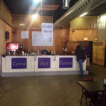 Fat's - a man standing at a counter in a restaurant - Chicken Wings Near Me - Winfield, Kansas