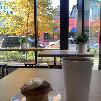 Evoke Cafe Bar - Large hot coffee and cinnamon bun on a cold day in Seattle - Cafes Near Me - Seattle, Washington