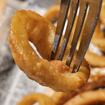 Lew's Restaurant - A fork holding an Onion Ring. - Pizza Near Me - Roanoke, Virginia