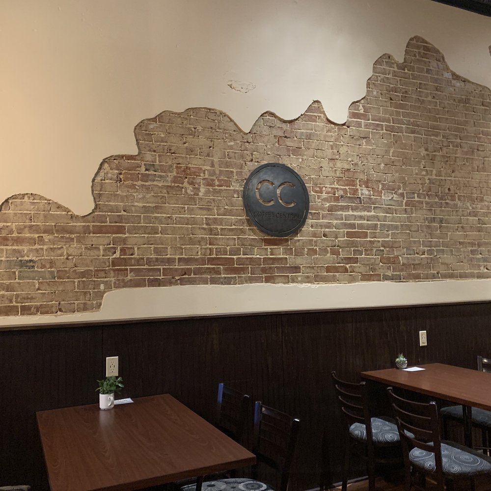a brick wall with a clock on it
