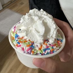 vanilla soft serve with whipped cream and rainbow sprinkles vanilla soft serve with whipped cream and rainbow sprinkles