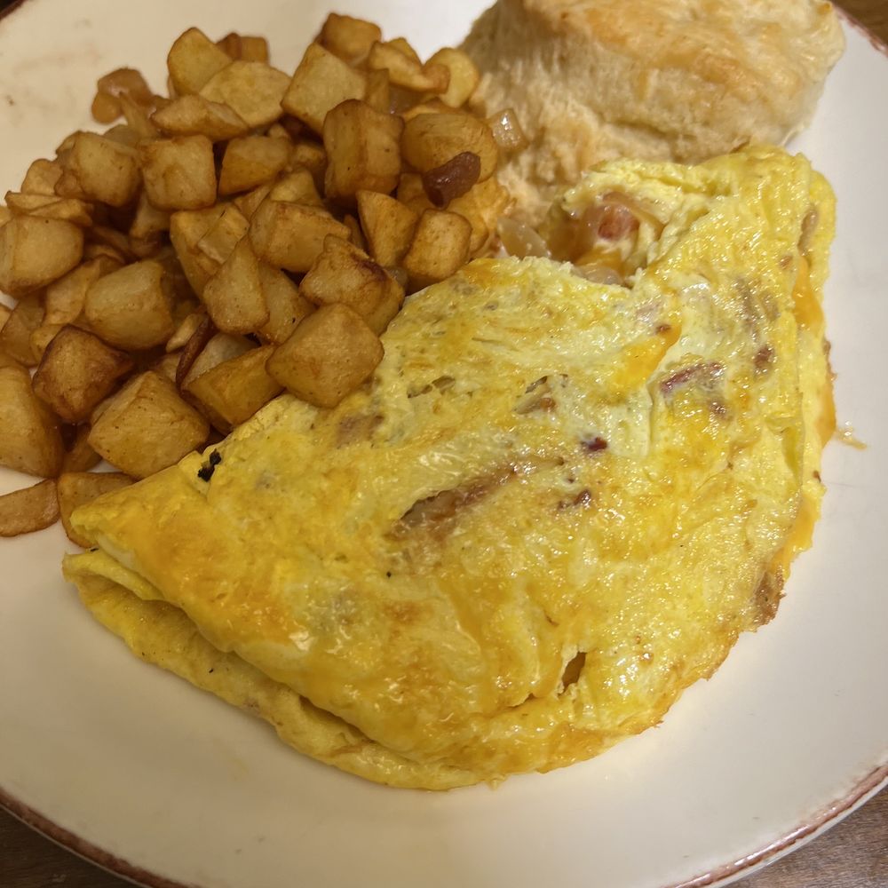 Omelet served with choice of home fries or grits, and biscuits or toast.