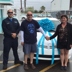 All Price Auto Sales - Coach Greg and his wife Dana with their 2004 Toyota Prius