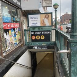 MTA - 36th St. Subway Station - D-N-R - 36 street D,N,R- Train .  ( Marashalls Department store  subway advertisement of opening there liberty industrial  grand opening near by )