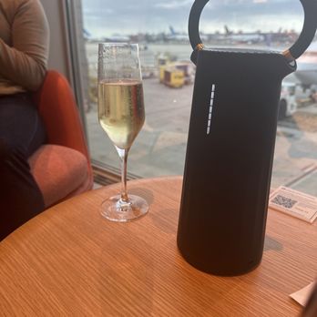 Etihad Lounge - Table top phone charger delivered by staff without asking - Airport Lounges Near Me - Dulles, Virginia