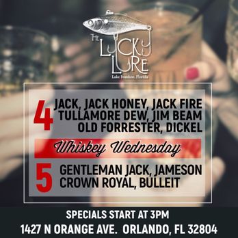 The Lucky Lure - a man holding a glass of whiskey - Bars Near Me - Orlando, Florida