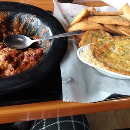 A chili bowl and a spinach dip with pita chips A chili bowl and a spinach dip with pita chips