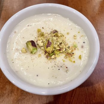 Bistro Aracosia - Firni (Milk Pudding Infused with Rose Water and Cardamom, Topped with Crushed Pistachios) - Afghan Near Me - Washington, DC, District of Columbia Bistro Aracosia - Firni (Milk Pudding Infused with Rose Water and Cardamom, Topped with Crushed Pistachios) - Afghan Near Me - Washington, DC, District of Columbia