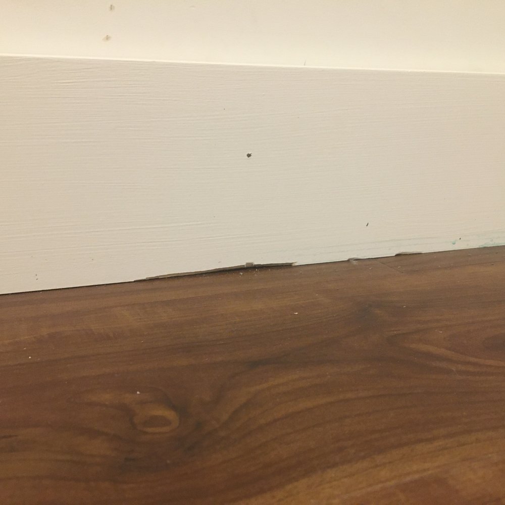 Kamaaina Flooring - baseboard damage that was not fixed - Carpet Installation Near Me