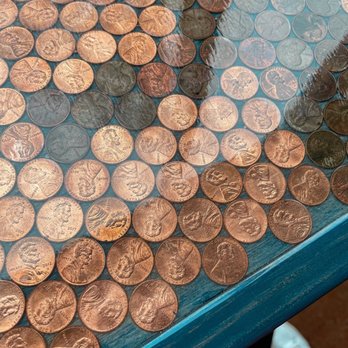 Equal Minded Cafe - a table covered with penns - Coffee & Tea Near Me - Kansas City, Missouri