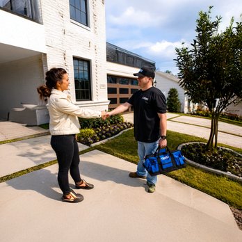 OGD Overhead Garage Door - An OGD technician greets a homeowner at the start of a garage door service visit. - Garage Door Services Near Me - Metairie, Louisiana OGD Overhead Garage Door - An OGD technician greets a homeowner at the start of a garage door service visit. - Garage Door Services Near Me - Metairie, Louisiana