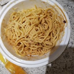 a bowl of noodles with chopsticks