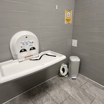 Cheeky Monkeys - Diaper changing area with diaper genie and spare toilet seat for littles - Indoor Playcenter Near Me - San Antonio, Texas