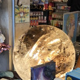 A massive smoky quartz sphere on display
