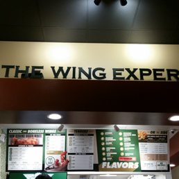 the wing experience sign above the counter the wing experience sign above the counter