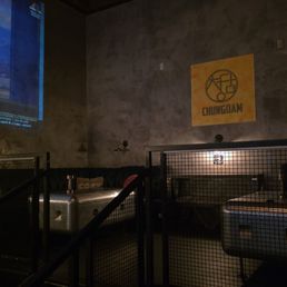 Raised platform, couch area, big screen showing videos if korea Raised platform, couch area, big screen showing videos if korea