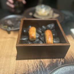 What we have here is a bread thing that was toasted on hot rocks as a part of amuse bouch.