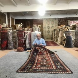 Bay Area Rug Cleaners - Ali repairing an antique handmade wool area rug - carpet. It is an antique wool Kazak area rug - carpet