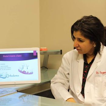 Triangle Orthodontics and General Dentistry - Dr. Farzana Rahman consulting with a patient. - Orthodontists Near Me - Durham, North Carolina Triangle Orthodontics and General Dentistry - Dr. Farzana Rahman consulting with a patient. - Orthodontists Near Me - Durham, North Carolina