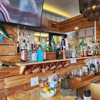 Mana + Pua - The liquor selection at the bar (minus the two gins being used to make our drinks) - Wine Bars Near Me - Honolulu, Hawaii