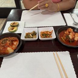 Sides. Left to Right. Fried Zucchini/Squash, kimchi, pickled jalapeños, sesame radish, and daikon radish.