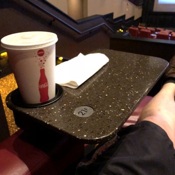 AMC Legends 14 - New table attached to each leather chair - this is the furthest away you can move it from your body. - Cinema Near Me - Kansas City, Kansas AMC Legends 14 - New table attached to each leather chair - this is the furthest away you can move it from your body. - Cinema Near Me - Kansas City, Kansas