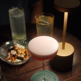 Pink Clover cocktail, high balls in the back Pink Clover cocktail, high balls in the back
