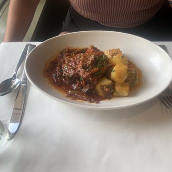 Herbsaint - Smothered Ryals Lamb Saddle: tomato, chilies, and brabant potatoes. - French Near Me - New Orleans, Louisiana Herbsaint - Smothered Ryals Lamb Saddle: tomato, chilies, and brabant potatoes. - French Near Me - New Orleans, Louisiana