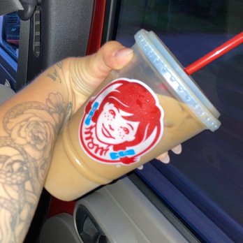 Wendy's - a hand holding a cup of iced coffee - Burgers Near Me - Coon Rapids, Minnesota