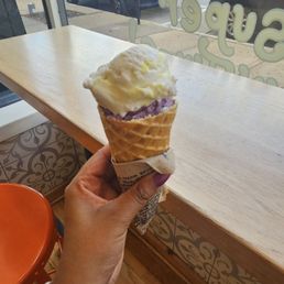 Waffle cone with lemon bar and wild lavender scoops Waffle cone with lemon bar and wild lavender scoops