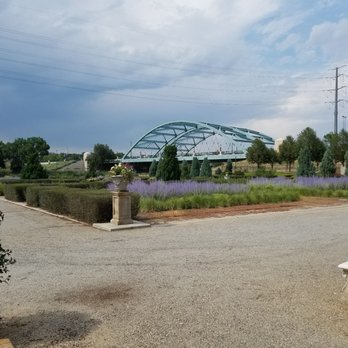 Centennial Gardens - Looking towards the Speer Boulevard Bridge across a South Platte River that is obscured by shrubs. - Parks Near Me - Denver, Colorado