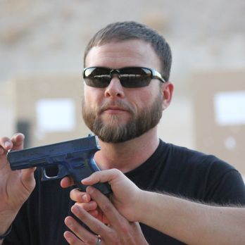 Dynamic Combative Solutions - Dave Laird helping a students understand recoil control using a blue training gun. - Firearm Training Near Me - Tempe, Arizona
