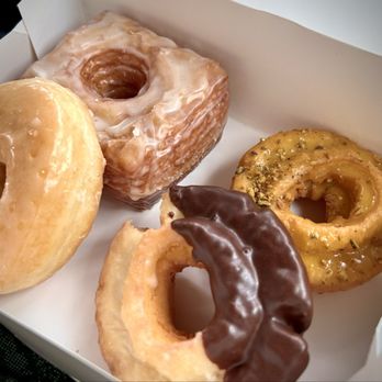 Donutly - Our box of Doughnuts and a Croughnut. (I suggest the pistachio-lime, top right!) - Donuts Near Me - Denton, Texas