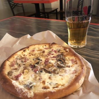 Back Unturned Brewing - Prosciutto and mushroom pizza with lager - Brewpubs Near Me - San Antonio, Texas