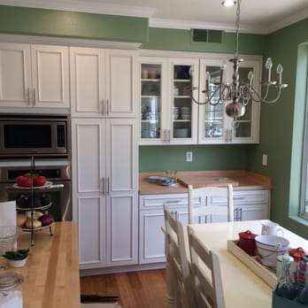 Pat Edwards Construction - a kitchen with green walls and white cabinets - General Contractors Near Me Pat Edwards Construction - a kitchen with green walls and white cabinets - General Contractors Near Me