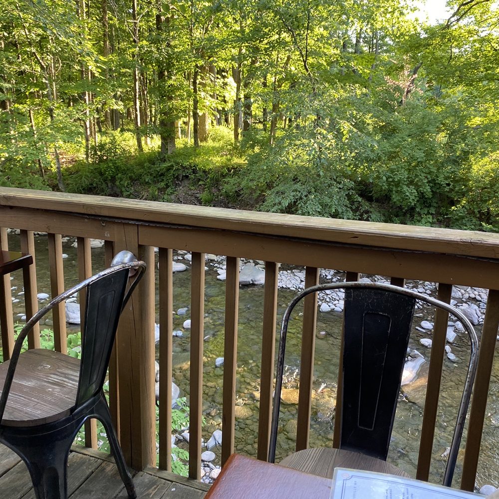 a view of a creek from a deck a view of a creek from a deck
