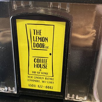 The Lemon Door - a yellow sign on the front of a microwave - Coffee & Tea Near Me - Fennimore, Wisconsin