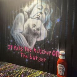 Boom Daddy's Burgers - The atmosphere here is undeniably fun! A view from inside our booth.