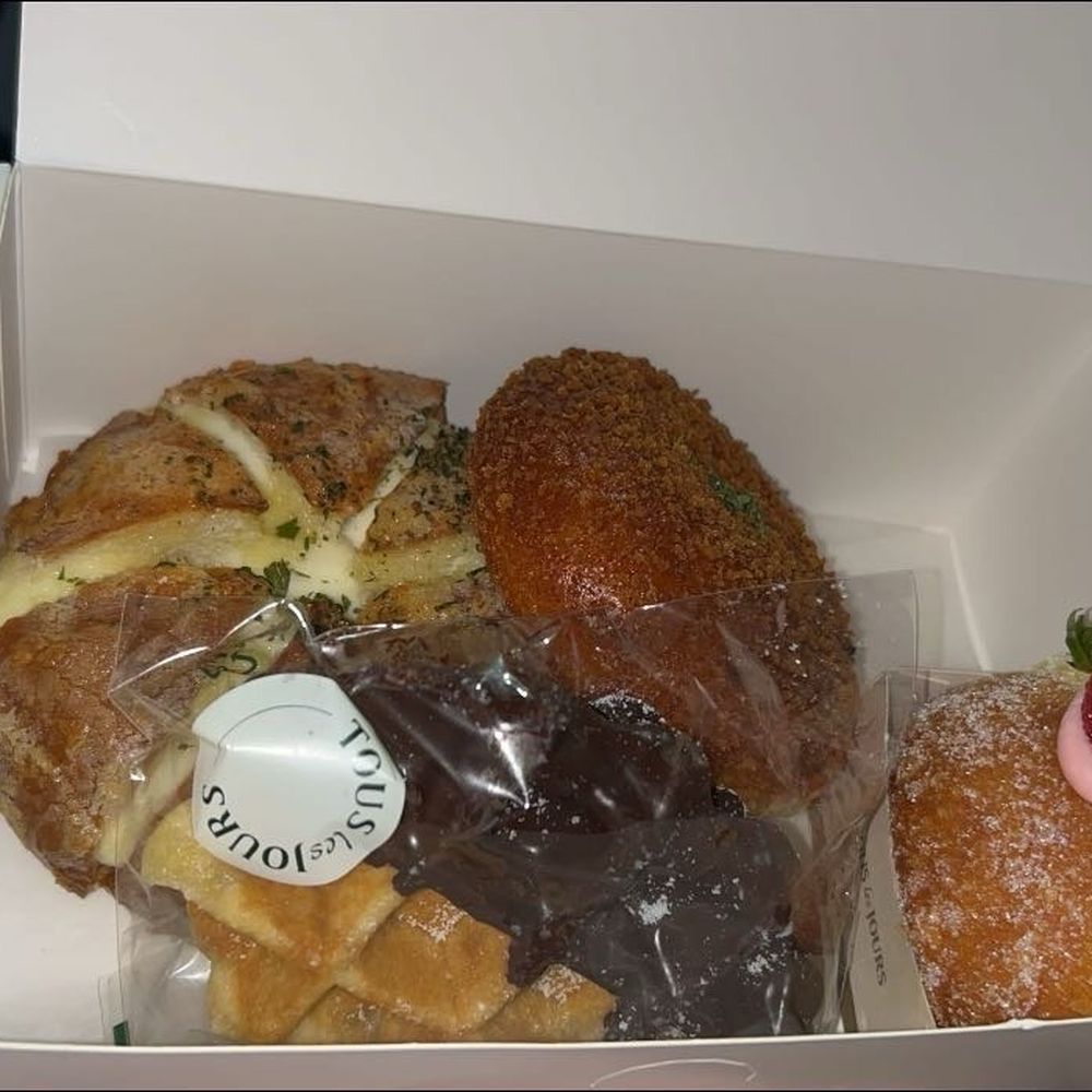 Chocolate dipped waffle, strawberry cream donut, kimchi croquette, and a garlic cheese bread Chocolate dipped waffle, strawberry cream donut, kimchi croquette, and a garlic cheese bread