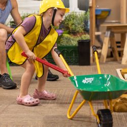 Children's Museum of Acadiana - Child shovels' rocks in Itty Bitty Builders Exhibit.