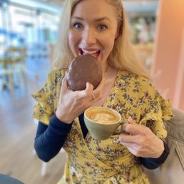 Enjoying a perfectly sized boston cream pie donut and latte
