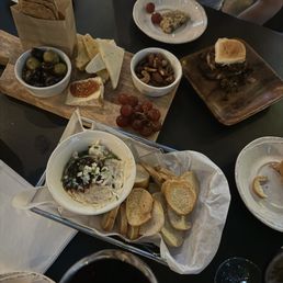 Goat cheese, cheese board, sliders, and wine