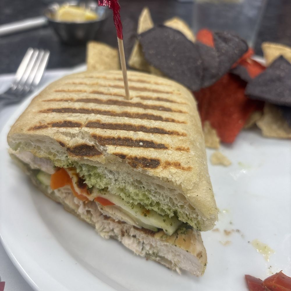 Chicken Pesto Panini with chips and salsa.