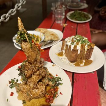 Nue - Chengdu Spicy Jumbo Chicken Wings, South African Bunny Chow, Side Roti Flatbread - Tapas/Small Plates Near Me - Seattle, Washington Nue - Chengdu Spicy Jumbo Chicken Wings, South African Bunny Chow, Side Roti Flatbread - Tapas/Small Plates Near Me - Seattle, Washington
