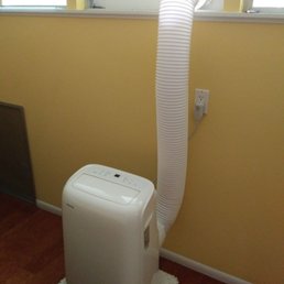 Portable AC installation vented through Jalousie window.