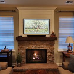 Rattan Patio & Fireplace Shoppe - After Photo. Rustic with a custom mantle and raised hearth.