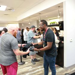 Story Cannabis - Tyree the Story of Waldorf manager welcoming new adult use cannabis customers on July 1 giving away Story swag.